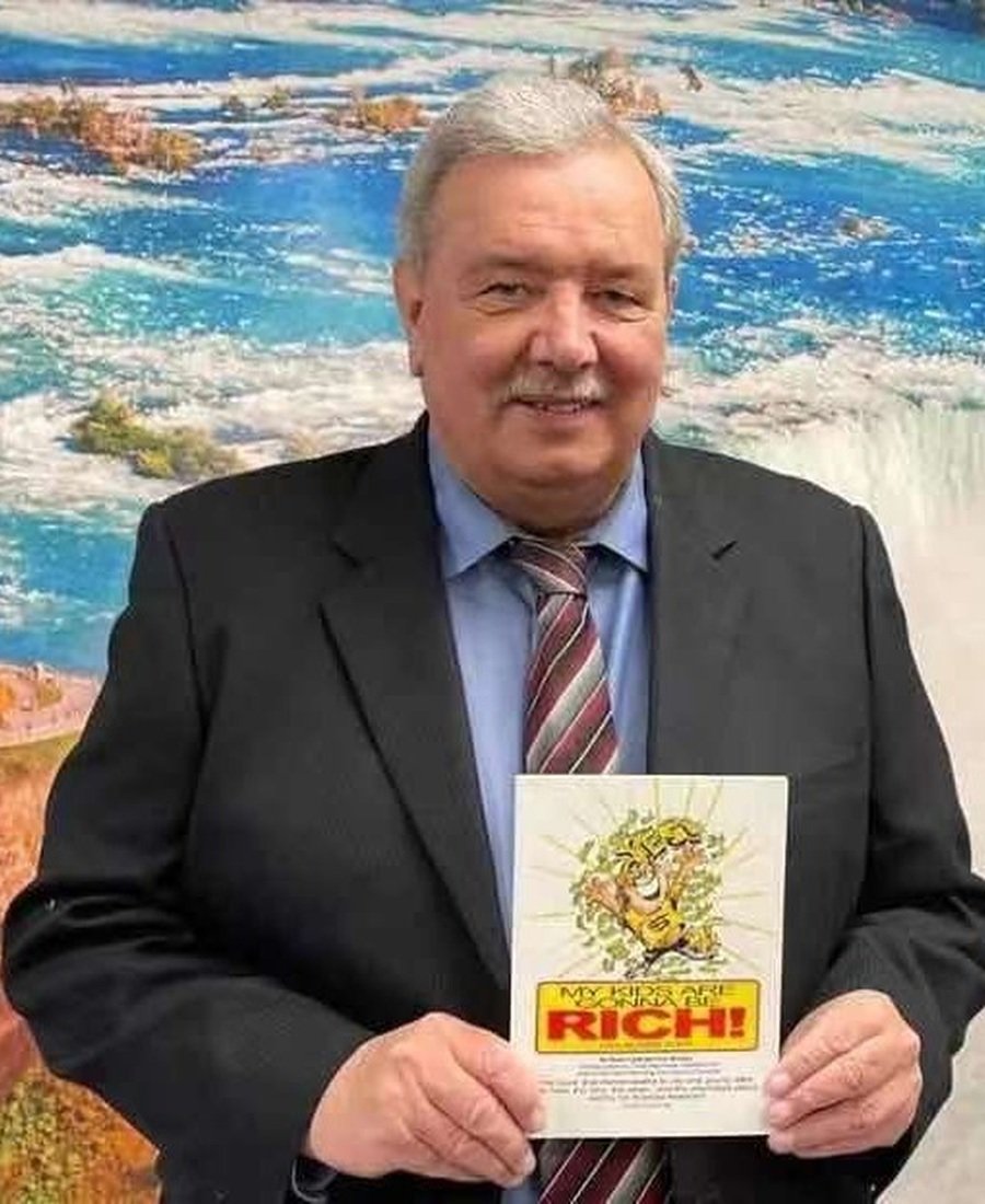 Stuart Lyall holding his book